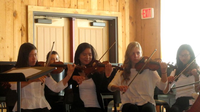 Greer is playing her violin