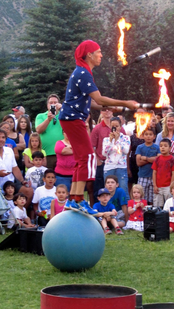 Juggling fire while standing on a ball???