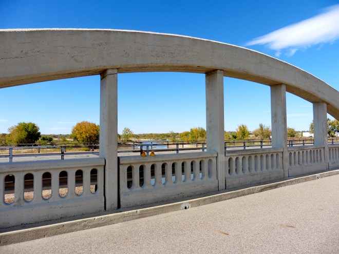 Looking through an arch and over the newer road for motorized traffic, to the South Platte River