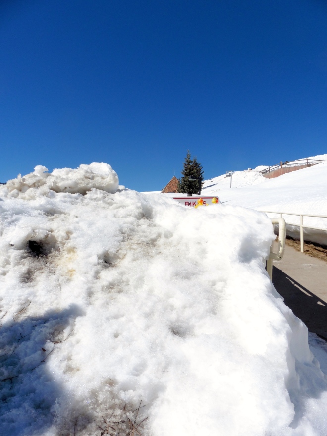 You can almost see the sign between the snow and bright blue sky