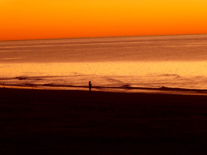 Beautiful Indian Ocean sunset with a lone fisherman