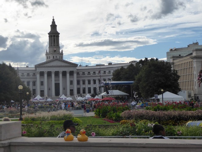 Listening to music. Denver City and County Building behind crowd