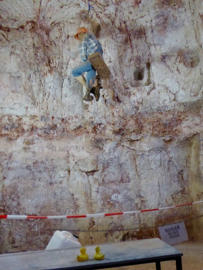 A fake miner using ropes to enter and exit the mine