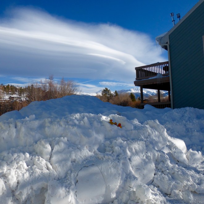 Snow pile and swirling clouds
