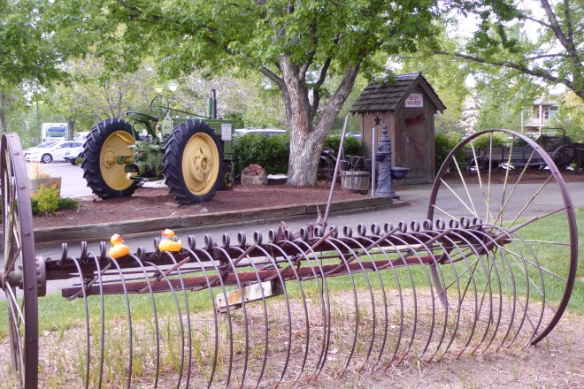 Farm equipment and outhouse