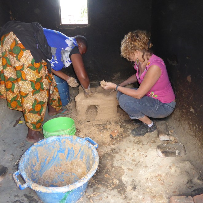 Putting final mud, or plaster, on new stove