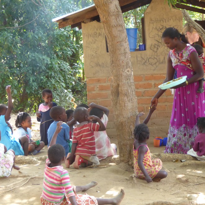 Handing out pieces of potato