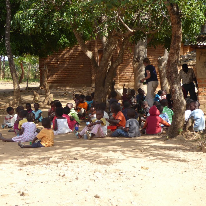 Students enjoying after school snack of sweet tea and potatoes 