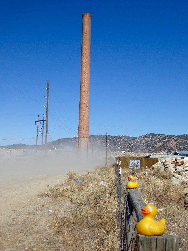 Smelter Smokestack by dusty road